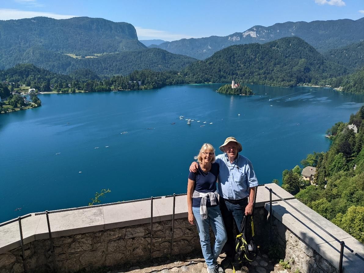 Photo from the 2022 Christmas letter: two people posing at an overlook above Lake Bled, Slovenia