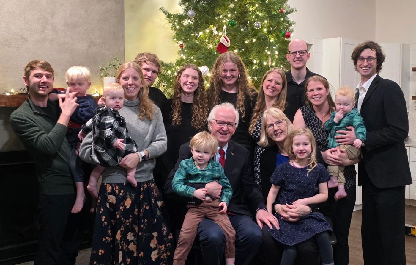 Photo from the 2025 Christmas letter: the King family gathered in front of a Christmas tree, Christmas 2025
